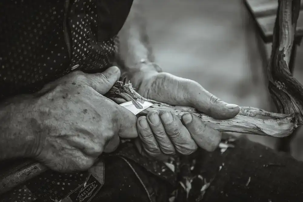 The founder of Whittle & Grain sanding a wooden toy