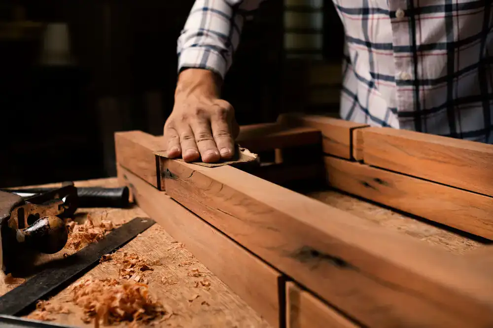 Artisan hands sanding a wooden block