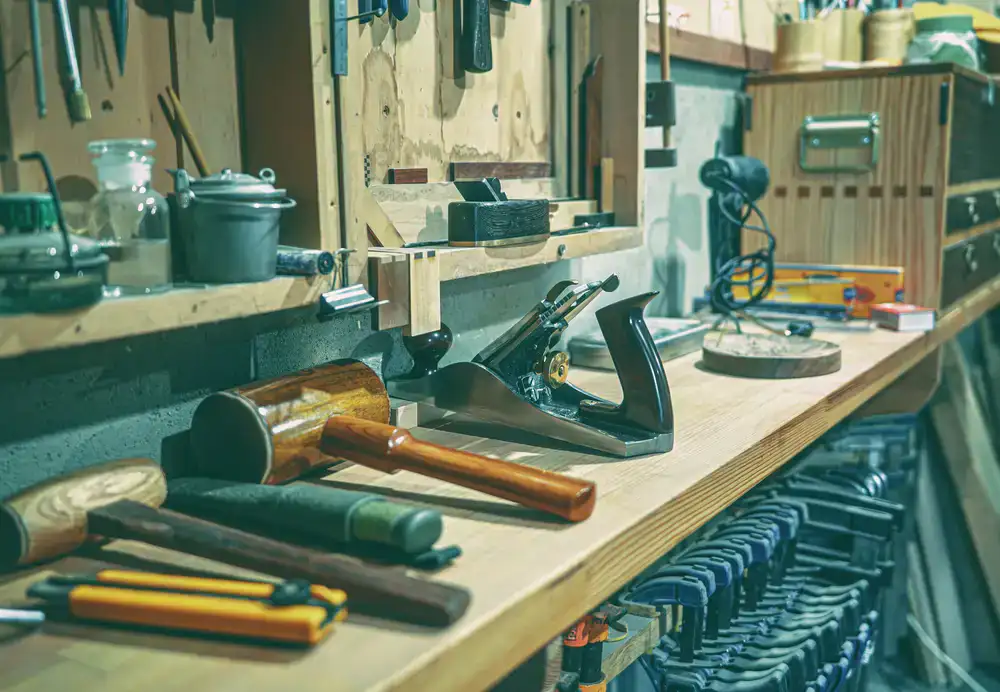 Vintage hand planes and chisels resting on a workbench